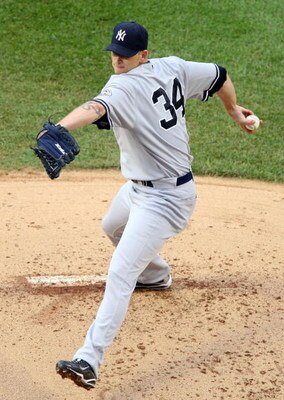 NEW YORK - MAY 05:  Josh Beckett #19 of the Boston Red Sox celebrates the final out of the sixth inning against the New York Yankees on May 5, 2009 at Yankee Stadium in the Bronx borough of New York City. The Red Sox defeated the Yankees 7-3.  (Photo by J