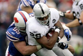 ORCHARD PARK, NY - SEPTEMBER 21: Michael Bush #29 of the Oakland Raiders is tackled by Kyle Williams #95 on September 21, 2008 at Ralph Wilson Stadium in Orchard Park, New York. Buffalo won 24-23. (Photo by Rick Stewart/Getty Images)