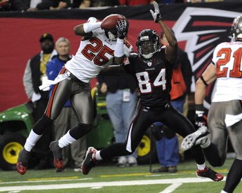 ATLANTA - DECEMBER 14:  Cornerback Aqib Talib #25 of the Tampa Bay Buccaneers intercepts a sideline pass against the Atlanta Falcons at the Georgia Dome on December 14, 2008 in Atlanta, Georgia.  (Photo by Al Messerschmidt/Getty Images)