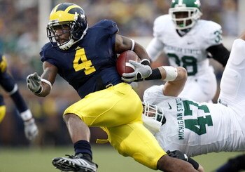 ANN ARBOR, MI - OCTOBER 25:  Brandon Minor #4 of the Michigan Wolverines tries to get around the tackle of Brandon Long #47 of the Michigan State Spartans during a third quarter run on October 25, 2008 at Michigan Stadium in Ann Arbor, Michigan. Michigan 