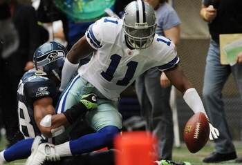 IRVING, TX - NOVEMBER 27:  Wide receiver Roy Williams #11 of the Dallas Cowboys is tackled by Julian Peterson #98 of the Seattle Seahawks at Texas Stadium on November 27, 2008 in Irving, Texas.  (Photo by Ronald Martinez/Getty Images)