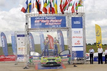 MIKOLAJKI, POLAND - JUNE 28:  Mikko Hirvonen and Jarmo Lehtinen of Finland celebrate their victory on the podium after the WRC Rally of Poland on June 28, 2009 in Mikolajki, Poland.  (Photo by Massimo Bettiol/Getty Images)