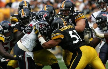 PITTSBURGH - SEPTEMBER 07:  Running back Steve Slaton #20 of the Houston Texans is tackled by Nick Eason #93, Lawrence Timmons #94, James Harrison #92, Travis Kirschke #90 and James Farrior #51 of the Pittsburgh Steelers on September 7, 2008 at Heinz Fiel