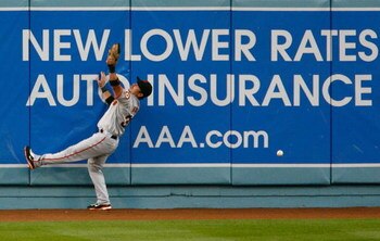 LOS ANGELES, CA - MAY 08:  Center fielder Aaron Rowand #33 of the San Francisco Giants can't make a catch on a hit by Rafael Furcal of the Los Angeles Dodgers in the first inning at Dodger Stadium on May 8, 2009 in Los Angeles, California.  (Photo by Jeff