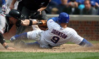CHICAGO - MAY 10: Reed Johnson #9 of the Chicago Cubs is tagged out at the plate by Chris Synder #19 of the Arizona Diamondbacks in the 5th inning on May 10, 2008 at Wrigley Field in Chicago, Illinois. (Photo by Jonathan Daniel/Getty Images)