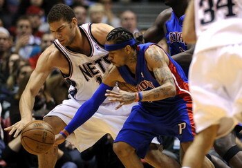 EAST RUTHERFORD, NJ - NOVEMBER 07:  Allen Iverson #1 of the Detroit Pistons and Brook Lopez #11 of the New Jersey Nets fight for a loose ball during their game November 7, 2008 at the Izod Arena in East Rutherford, New Jersey.  (Photo by Jeff Zelevansky/G