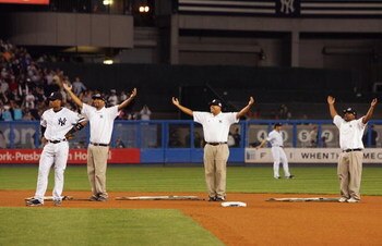 NEW YORK - SEPTEMBER 21: The grounds crew perform the 'YMCA' between innings of the New York Yankees game agaionst Baltimore Orioles during the last regular season game at Yankee Stadium on September 21, 2008 in the Bronx borough of New York City. The Yan