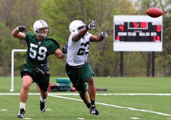 FLORHAM PARK, NJ - MAY 02:  Shonn Greene #23 of the New York Jets practices against Brian Toal #59 during minicamp on May 2, 2009 at the Atlantic Health Jets Training Center in Florham Park, New Jersey.  (Photo by Jim McIsaac/Getty Images)