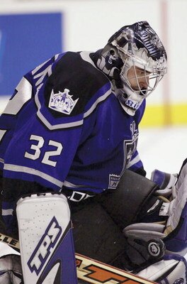 LOS ANGELES - NOVEMBER 13:  Goaltender Roman Cechmanek #32 of the Los Angeles Kings gets a pad on a shot by the Toronto Maple Leafs on November 13, 2003 at Staples Center in Los Angeles, California.  (Photo by Victor Decolongon/Getty Images)