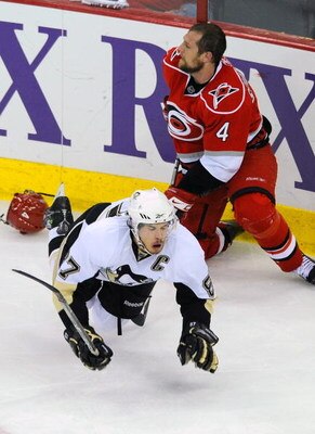 RALEIGH, NC - MAY 26:  Dennis Seidenberg #4 of the Carolina Hurricanes trips Sidney Crosby #87 of the Pittsburgh Penguins during Game Four of the Eastern Conference Championship Round of the 2009 Stanley Cup Playoffs at RBC Center May 26, 2009 in Raleigh,