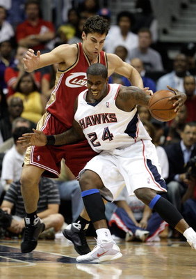ATLANTA - MAY 11: Marvin Williams #24 of the Atlanta Hawks drives into Wally Szczerbiak #10 of the Cleveland Cavaliers during Game Four of the Eastern Conference Semifinals during the 2009 NBA Playoffs at Philips Arena on May 11, 2009 in Atlanta, Georgia