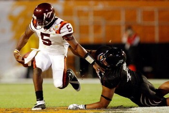 MIAMI - JANUARY 01:  John Hughes # 40 of the Cincinnati Bearcats tackles Tyrod Taylor #5 of the Virginia Tech Hokies as he loses the ball during the FedEx Orange Bowl at Dolphin Stadium on January 1, 2009 in Miami, Florida.  (Photo by Streeter Lecka/Getty
