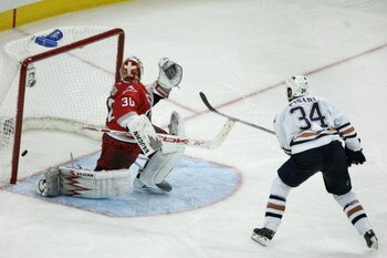 RALEIGH, NC - JUNE 14:  Fernando Pisani #34 of the Edmonton Oilers scores a short handed game winning goal past goaltender Cam Ward #30 of the Carolina Hurricanes in game five of the 2006 NHL Stanley Cup Finals on June 14, 2006 at the RBC Center in Raleig
