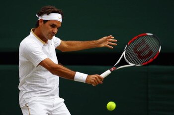 WIMBLEDON, ENGLAND - JULY 03:  Roger Federer of Switzerland plays a backhand during the men's singles semi final match against Tommy Haas of Germany on Day Eleven of the Wimbledon Lawn Tennis Championships at the All England Lawn Tennis and Croquet Club o