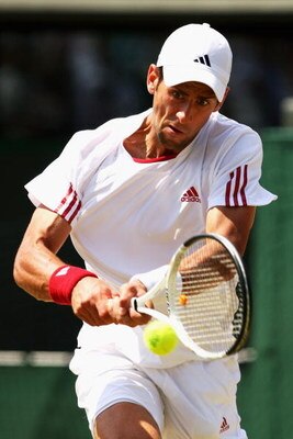 WIMBLEDON, ENGLAND - JULY 01:  Novak Djokovic of Serbia plays backhand during the men's singles quarter final match against Tommy Haas of Germany on Day Nine of the Wimbledon Lawn Tennis Championships at the All England Lawn Tennis and Croquet Club on Jul