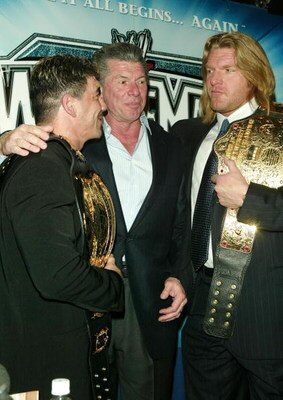 NEW YORK - MARCH 11:  (L-R) Wrestler Eddie Guerrero, WWE Chairman Vince McMahon and Wrestler Triple H attend a press conference to promote Wrestlemania XX at Planet Hollywood March 11, 2004 in New York City.  (Photo by Peter Kramer/Getty Images)