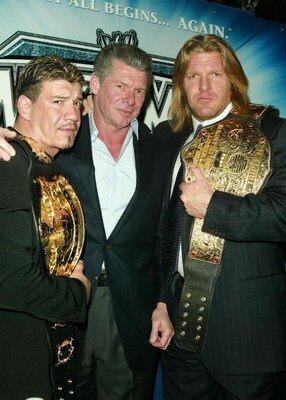 NEW YORK - MARCH 11:  (L-R) Wrestler Eddie Guerrero, WWE Chairman Vince McMahon and Wrestler Triple H attend a press conference to promote Wrestlemania XX at Planet Hollywood March 11, 2004 in New York City.  (Photo by Peter Kramer/Getty Images)