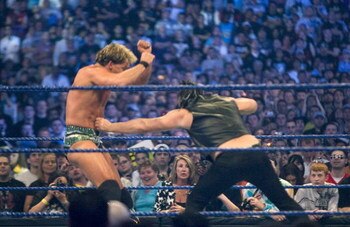 HOUSTON, TX - APRIL 5: (L-R) WWE Superstar Chris Jericho gets a punch to the gut by actor Mickey Rourke as they duel during WrestleMania 25 at Reliant Stadium on April 5, 2009 in Houston, Texas.  (Photo by Bill Olive/Getty Images)