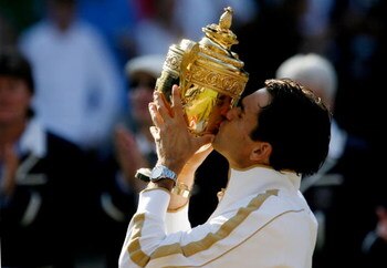 WIMBLEDON, ENGLAND - JULY 05:  Roger Federer of Switzerland kisses the trophy after victory during the men's singles final match against Andy Roddick of USA on Day Thirteen of the Wimbledon Lawn Tennis Championships at the All England Lawn Tennis and Croq