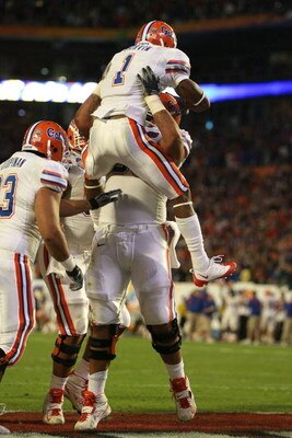 MIAMI - JANUARY 08:  Percy Harvin #1 of the Florida Gators celebrates with teammates after he scored a 2-yard rushing touchdown in the third quarter against the Oklahoma Sooners during the FedEx BCS National Championship game at Dolphin Stadium on January