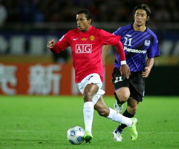 YOKOHAMA, JAPAN - DECEMBER 18: Akira Kaji  of Gamba Osaka and Nani of Manchester United compete for the ball during the FIFA Club World Cup Japan 2008 semi final match between Gamba Osaka and Manchester United at the International Stadium Yokohama on Dece