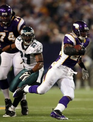 MINNEAPOLIS - JANUARY 4:   Adrian Peterson #28 of the Minnesota Vikings runs past Quentin Mikell #27 of the Philadelphia Eagles during the NFC Wild Card playoff game on January 4,2009 at the Hubert H. Humphrey Metrodome in Minneapolis, Minnesota. (Photo b