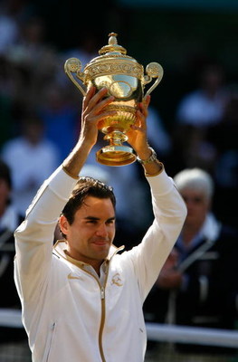 WIMBLEDON, ENGLAND - JULY 05: Roger Federer of Switzerland celebrates victory with the trophy after the men's singles final match against Andy Roddick of USA on Day Thirteen of the Wimbledon Lawn Tennis Championships at the All England Lawn Tennis and Cr