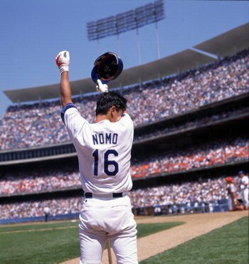30 Jul 1995: Pitcher Hideo Nomo of the Los Angeles Dodgers wipes the sweat from his forehead while standing in the on deck circle waiting for his at-bat during the Dodgers 5-4 victory over the Cincinnati Reds at Dodger Stadium in Los Angeles, California.