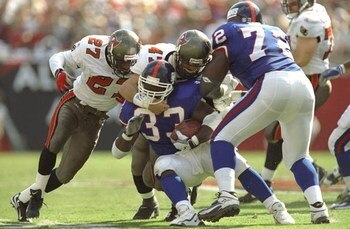 4 Oct 1998:  Runningback Gary Brown #33 of the New York Giants is tackled by Anthony Parker #27 of the Tampa Bay Buccaneers during a game at the Raymond James Stadium in Tampa, Florida. The Buccaneers defeated the Giants 20-3.
