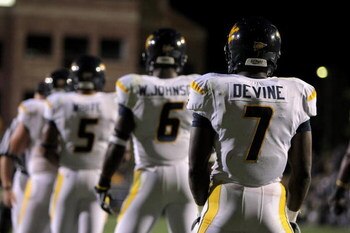 BOULDER, CO - SEPTEMBER 18:  Quarterback Pat White #5 of the West Virginia Mountaineers along with Will Johnson #6 and Noel Devine #7 line up in the back field against the Colorado Buffaloes at Folsom Field on September 18, 2008 in Boulder, Colorado. Colo