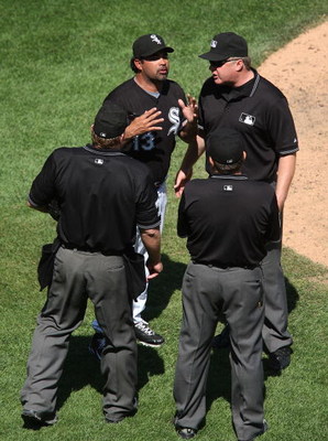 CHICAGO - JUNE 28: Manager Ozzie Guillen #13 of the Chicago White Sox argues with umpires (L-R) Brain Runge #71, Derryl Cousins #13 and Bill Miller #26 during a game against the Chicago Cubs on June 28, 2009 at U.S. Cellular Field in Chicago, Illinois. (P
