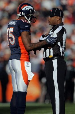 DENVER - NOVEMBER 23:  Wide receiver Brandon Marshall #15 of the Denver Broncos chats with field judge Boris Cheek as the Broncos face the Oakland Raiders during week 12 NFL action at Invesco Field at Mile High on November 23, 2008 in Denver, Colorado. Th
