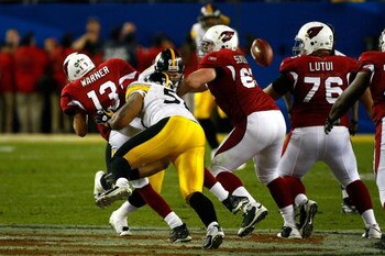 TAMPA, FL - FEBRUARY 01:  Quarterback Kurt Warner #13 of the Arizona Cardinals fumbles the ball with :15 seconds to play as he is sacked by LaMarr Woodley #56 of the Pittsburgh Steelers during Super Bowl XLIII on February 1, 2009 at Raymond James Stadium 
