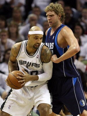 SAN ANTONIO - APRIL 18:  Forward Drew Gooden #90 of the San Antonio Spurs dribbles the ball past Dirk Nowitzki #41 of the Dallas Mavericks in Game One of the Western Conference Quarterfinals during the 2009 NBA Playoffs at AT&T Center on April 18, 2009 in