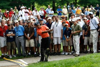 BETHESDA, MD - JULY 02:  Tiger Woods hits from the gallery on his third shot of the 16th hole during the first round of the AT&T National at the Congressional Country Club on July 2, 2009 in Bethesda, Maryland.  (Photo by Win McNamee/Getty Images)