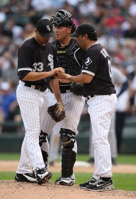 CHICAGO - AUGUST 23: Manager Ozzie Guillen #13 of the Chicago White Sox (R) takes the ball from starting pitcher Javier Vazquez #33 as catcher Toby Hall looks to the bullpen in the 8th inning against the Tampa Bay Rays on August 23, 2008 at U.S. Cellular 
