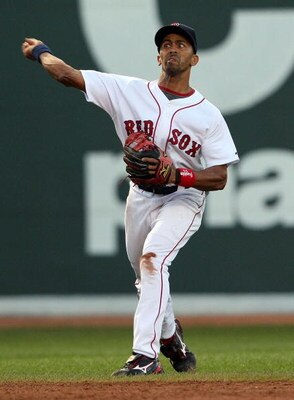BOSTON - JULY 06:  Julio Lugo #23 of the Boston Red Sox over throws the ball to first base in the first inning against the Oakland Athletics on July 6, 2009 at Fenway Park in Boston, Massachusetts. The Athletics defeated the Red Sox 6-0. (Photo by Elsa/Ge