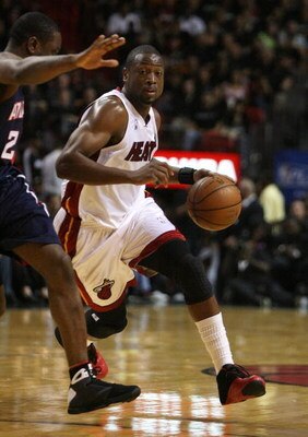 MIAMI - APRIL 27:  Dwyane Wade #3 of the Miami Heat drives around Joe Johnson #2 of the Atlanta Hawks during Game Four of the Eastern Conference Quarterfinals of the 2009 NBA Playoffs at American Airlines Arena on April 27, 2009 in Miami, Florida. The Haw