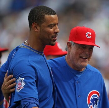 CHICAGO - JULY 03: Derrek Lee #25 and Manager Lou Piniella #41 of the Chicago Cubs celebrate a win over the Milwaukee Brewers on July 3, 2009 at Wrigley Field in Chicago, Illinois. The Cubs defeated the Brewers 2-1 in 10 innings. (Photo by Jonathan Daniel
