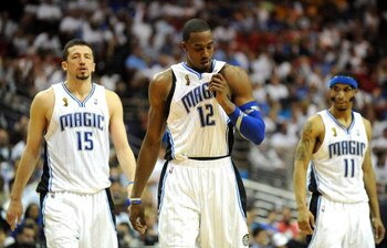 ORLANDO, FL - JUNE 14:  (L-R) Hedo Turkoglu #15, Dwight Howard #12 and Courtney Lee #11 of the Orlando Magic walk across the court in the final moments of the Magic loss to the Los Angeles Lakers in Game Five of the 2009 NBA Finals on June 14, 2009 at Amw