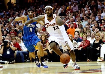 CLEVELAND - MAY 28:  LeBron James #23 of the Cleveland Cavaliers drives to the hoop against Courtney Lee #11 of the Orlando Magic in Game Five of the Eastern Conference Finals during the 2009 Playoffs at Quicken Loans Arena on May 28, 2009 in Cleveland, O