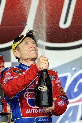 JOLIET, IL - JULY 11:  Mark Martin, driver of the #5 CARQUEST/Kellogg's Chevrolet, celebrates in victory lane after winning the NASCAR Sprint Cup Series LifeLock.com 400 at Chicagoland Speedway on July 11, 2009 in Joliet, Illinois.  (Photo by John Harrels