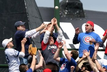 CHICAGO - MAY 02: Fans in the left field bleachers try to catch a home run ball hit by Cody Ross of the Florida Marlins in the 5th inning against the Chicago Cubs on May 2, 2009 at Wrigley Field in Chicago, Illinois. The Cubs defeated the MArlins 6-1. (Ph