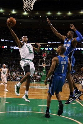 BOSTON - MAY 17:  Rajon Rondo #9 of the Boston Celtics heads to the basket as Rafer Alston #1 and Dwight Howard #12 of the Orlando Magic defend in Game Seven of the Eastern Conference Semifinals during the 2009 NBA Playoffs at TD Banknorth Garden on May 1