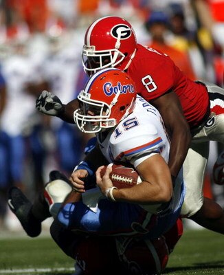 JACKSONVILLE, FL - OCTOBER 28:  Tim Tebow #15 of the University of Florida Gators is brought down by Paul Oliver #8 of the University of Georgia Bulldogs at Alltel  Stadium on October 28, 2006 in Jacksonville, Florida. Florida defeated Georgia 21-14.  (Ph
