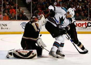 ANAHEIM, CA - APRIL 27:  Jonas Hiller #1 of the Anaheim Ducks blocks a shot behind Milan Michalek #9 of the San Jose Sharks during Game Six of the Western Conference Quarterfinal Round of the 2009 Stanley Cup Playoffs at the Honda Center on April 27, 2009