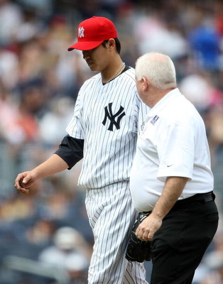 NEW YORK - JULY 04: Chien-Ming Wang #40 of the New York Yankees leaves the game in the sixth inning with a strained right shoulder against the Toronto Blue Jays on July 4, 2009 at Yankee Stadium in the Bronx borough of New York City. (Photo by Nick Laha