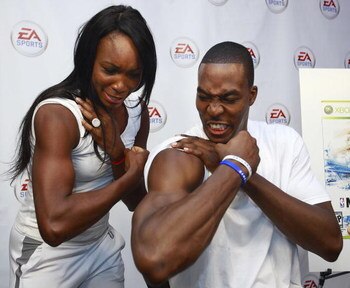 BURNABY, CANADA - JULY 13: In this photo provided by EA Sports, Dwight Howard of the NBA's Orlando Magic and tennis star Venus Williams compare their biceps during the EA Sports King of the Court competition July 13,2009 in Burnaby, Canada.  Dwight Howard