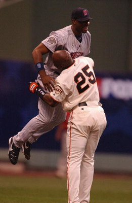 MILWAUKEE, WI - JULY 9: Barry Bonds #25 of the National league lifts Toril Hunter #48 of the American League after Hunter caught a ball hit by Bonds to the wall in the first inning during the MLB All Star Game July 9, 2002 at Miller Park in Milwaukee, Wis