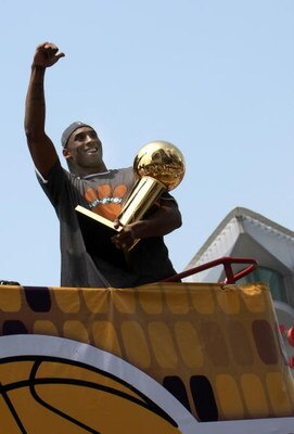 LOS ANGELES, CA - JUNE 17:  Kobe Bryant #24 holds the Larry O'Brien trophy and waves to the crowd from the top of a double decker bus at the start of the Los Angeles Lakers NBA championship victory parade outside the Staples Center on June 17, 2009 in Los